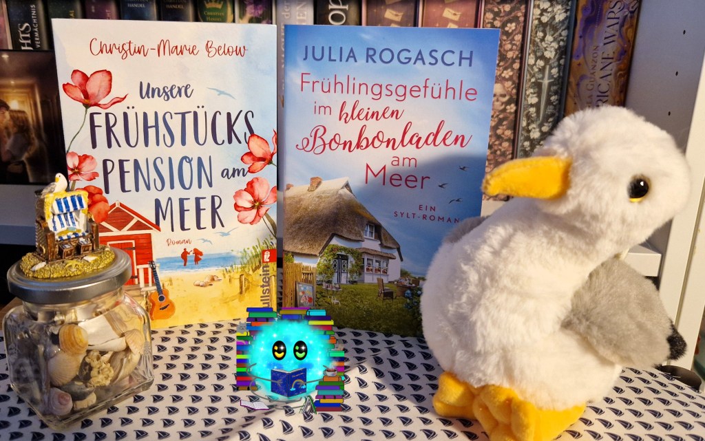 Die beiden Bücher arrangiert mit Möweplüsh, Muschelglas und kleine Figur eines Strandkorbs