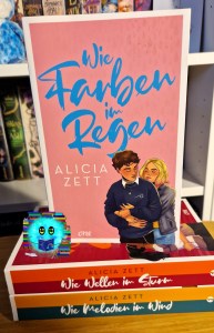 Cover zu Wie Farben im Regen mit den beiden Protagonist*innen, wo sie ihn von hinten umarmt